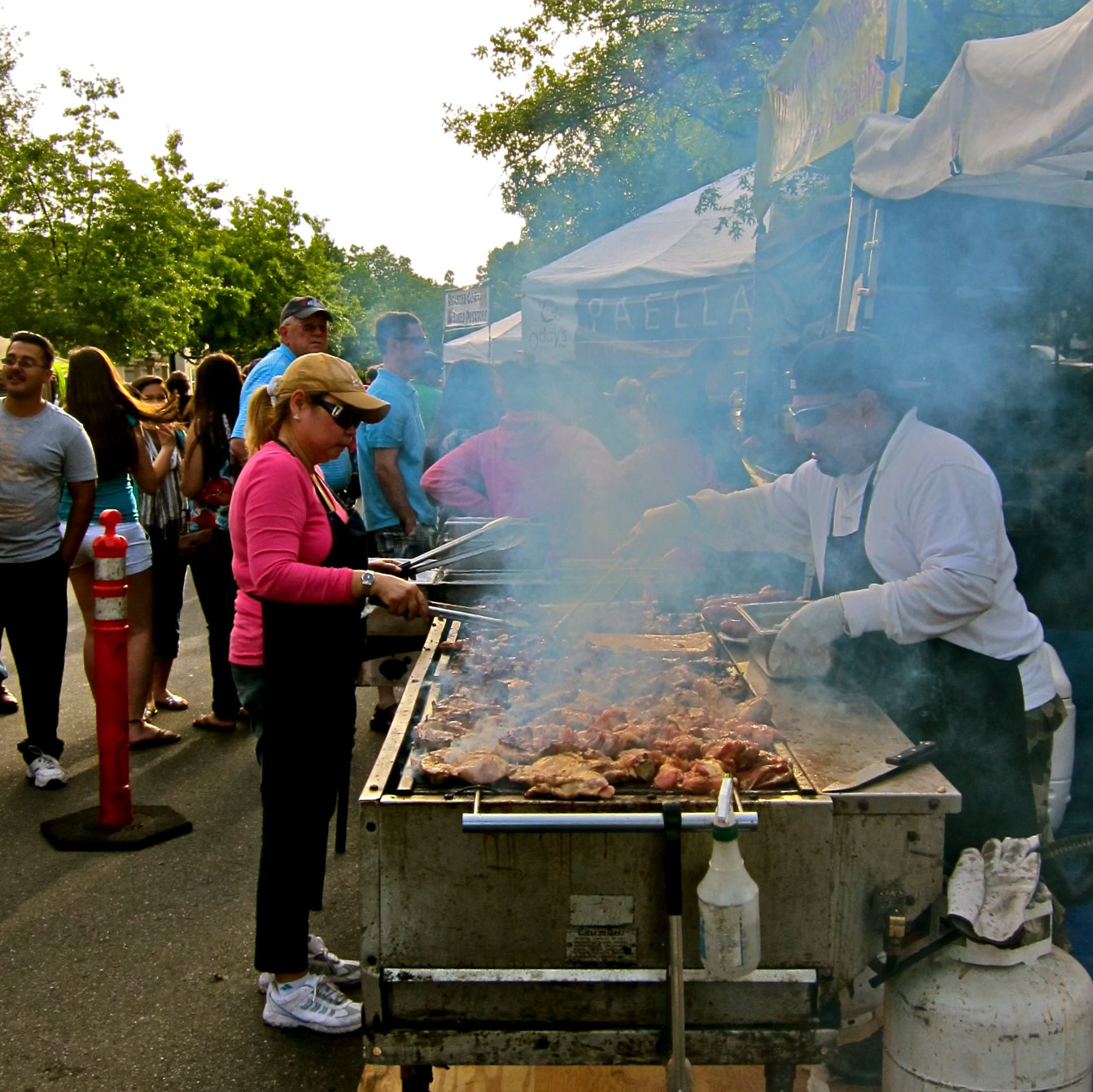 People enjoying a barbecue at a Lodi wine event with grilling and outdoor setting.
