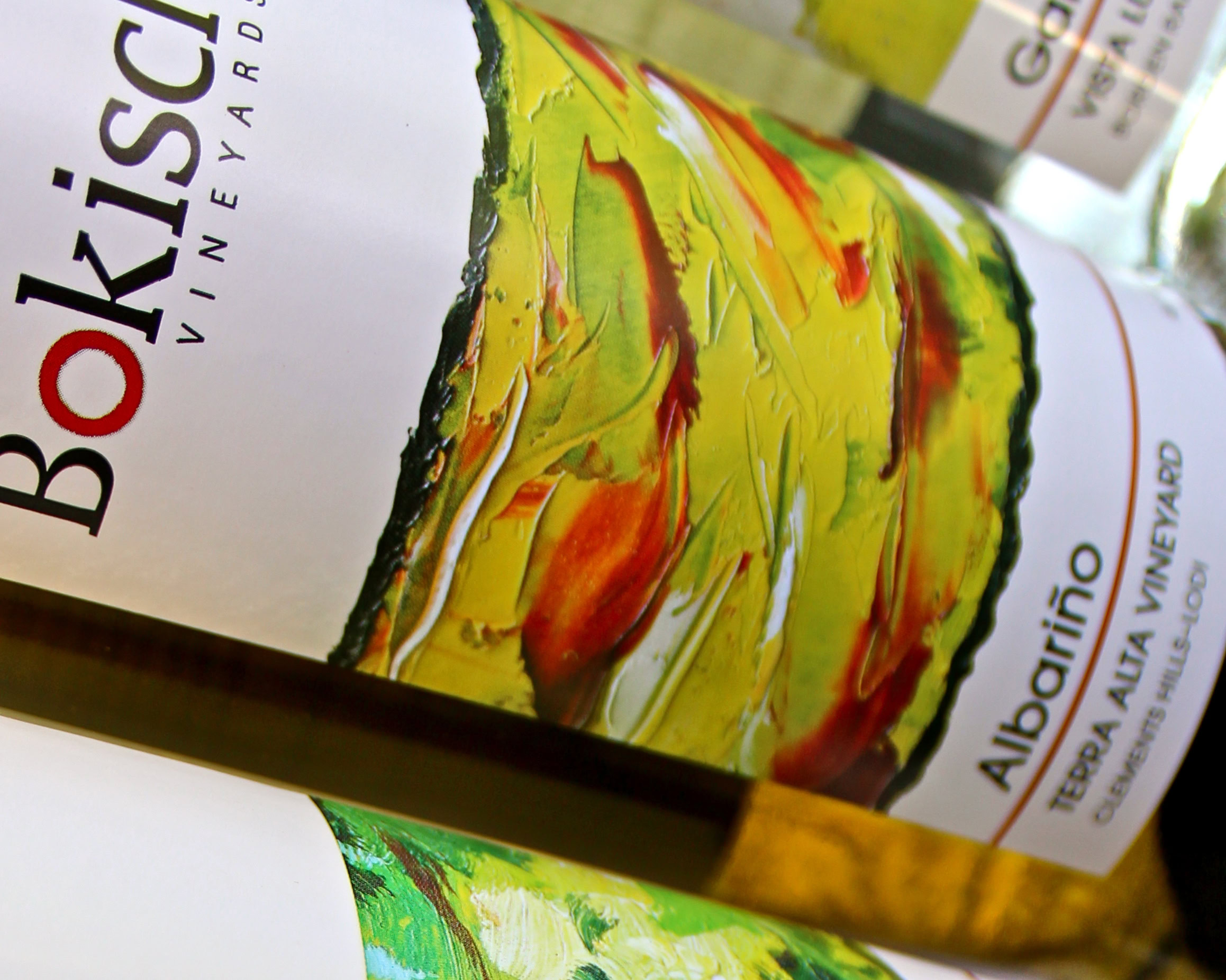 Close-up of a wine bottle label from Lodi Winegrape Commission, featuring vibrant artwork and branding details.