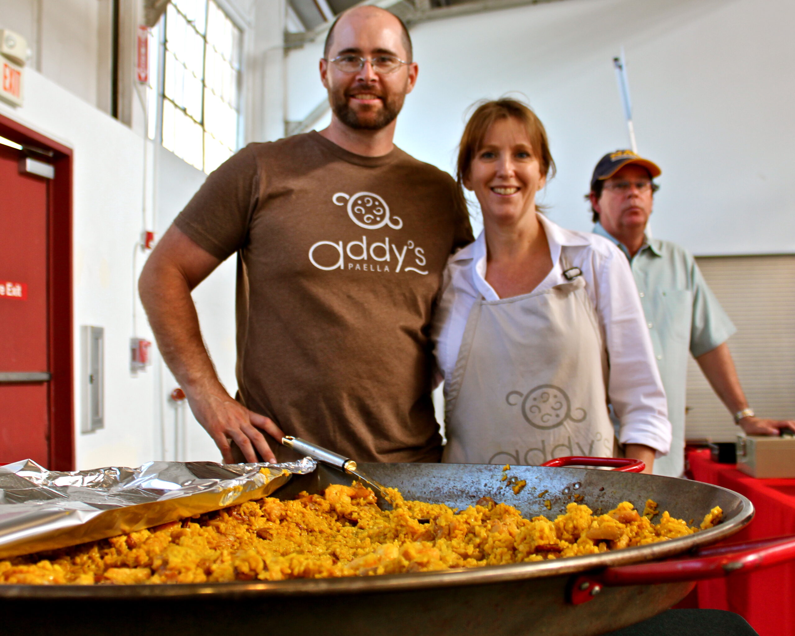 People at a Lodi Winegrape Commission event with food and wine in a bright indoor setting.