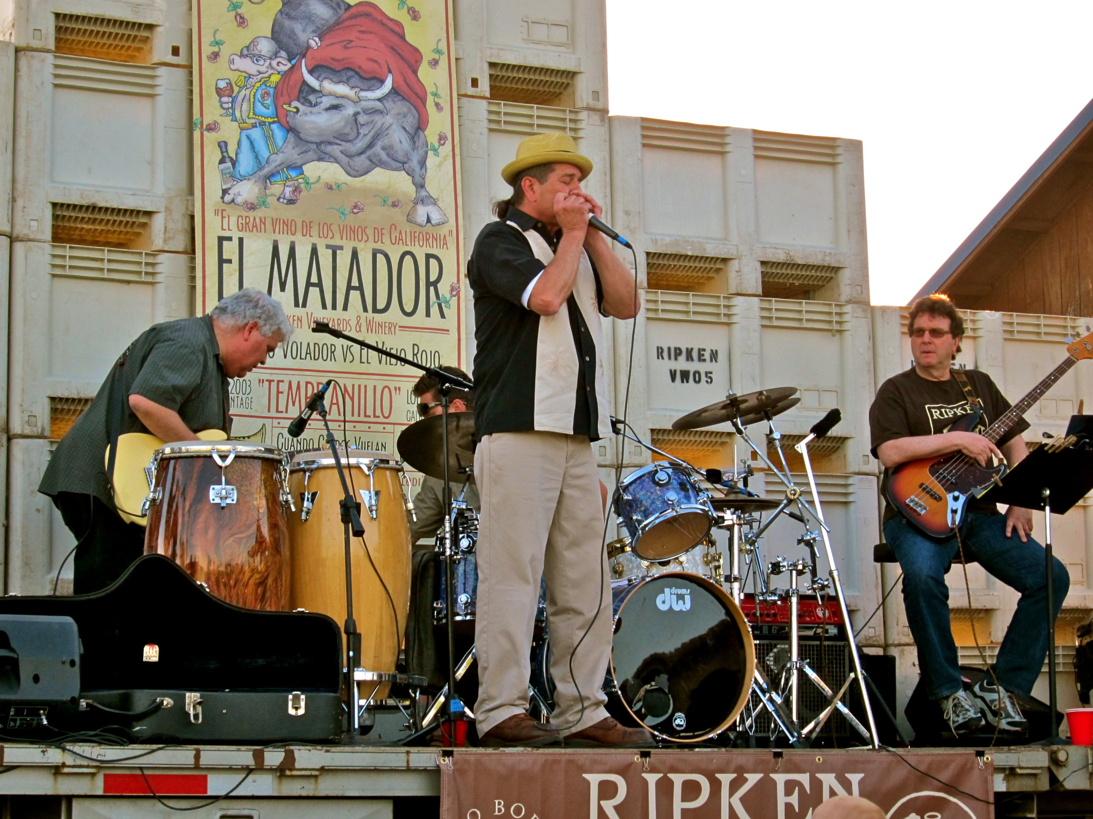Live music performance at Lodi Winegrape Commission event with band playing instruments on stage.
