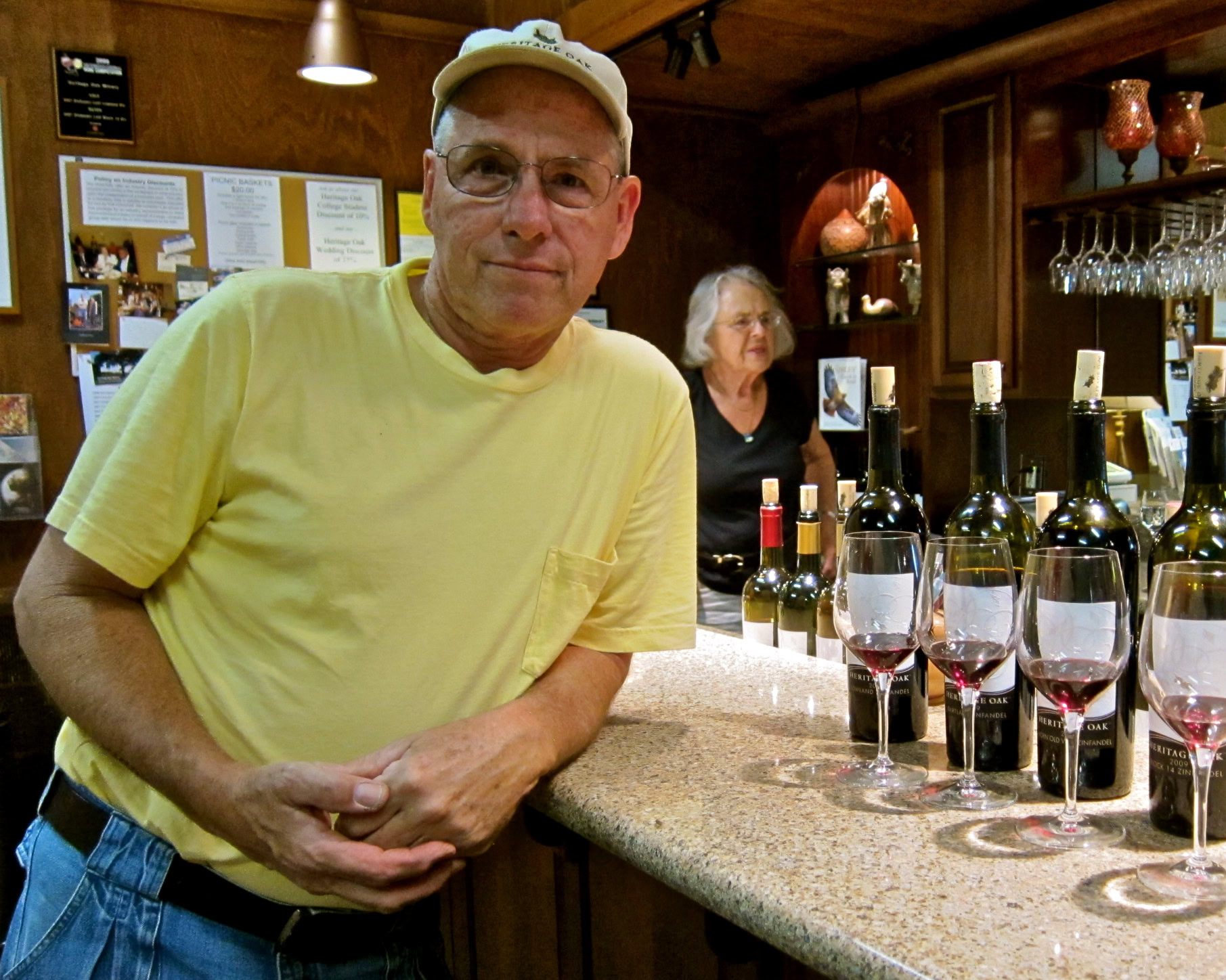 Man tasting wine at Lodi Winegrape Commission tasting event with bottles and glasses on the bar.