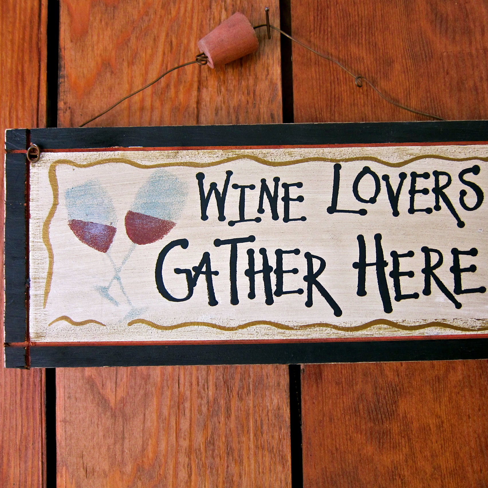 Hand-painted sign for wine lovers with glasses of red wine on a wooden background.