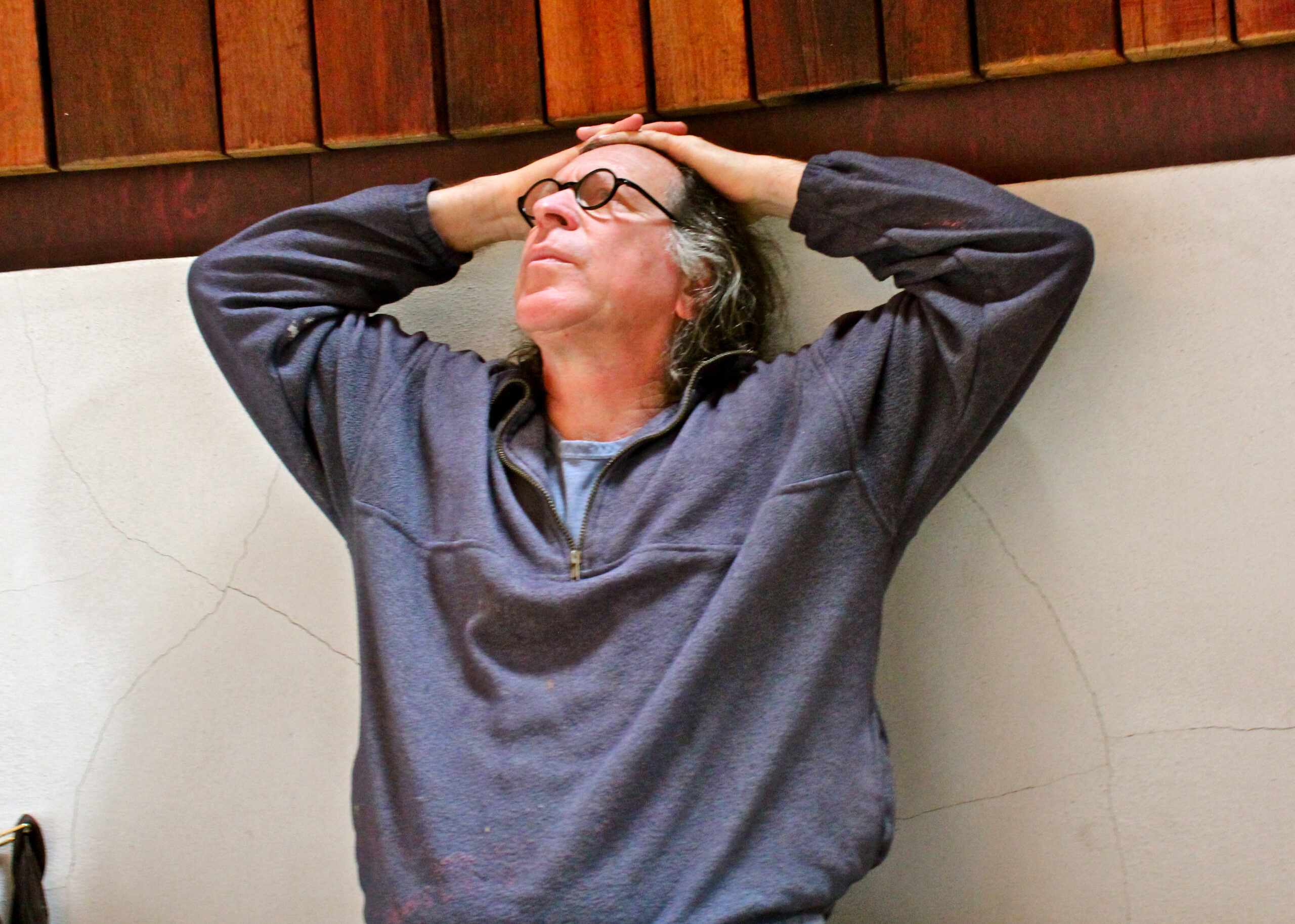 Man with glasses relaxing with hands on head at Lodi Winegrape Commission event or location.