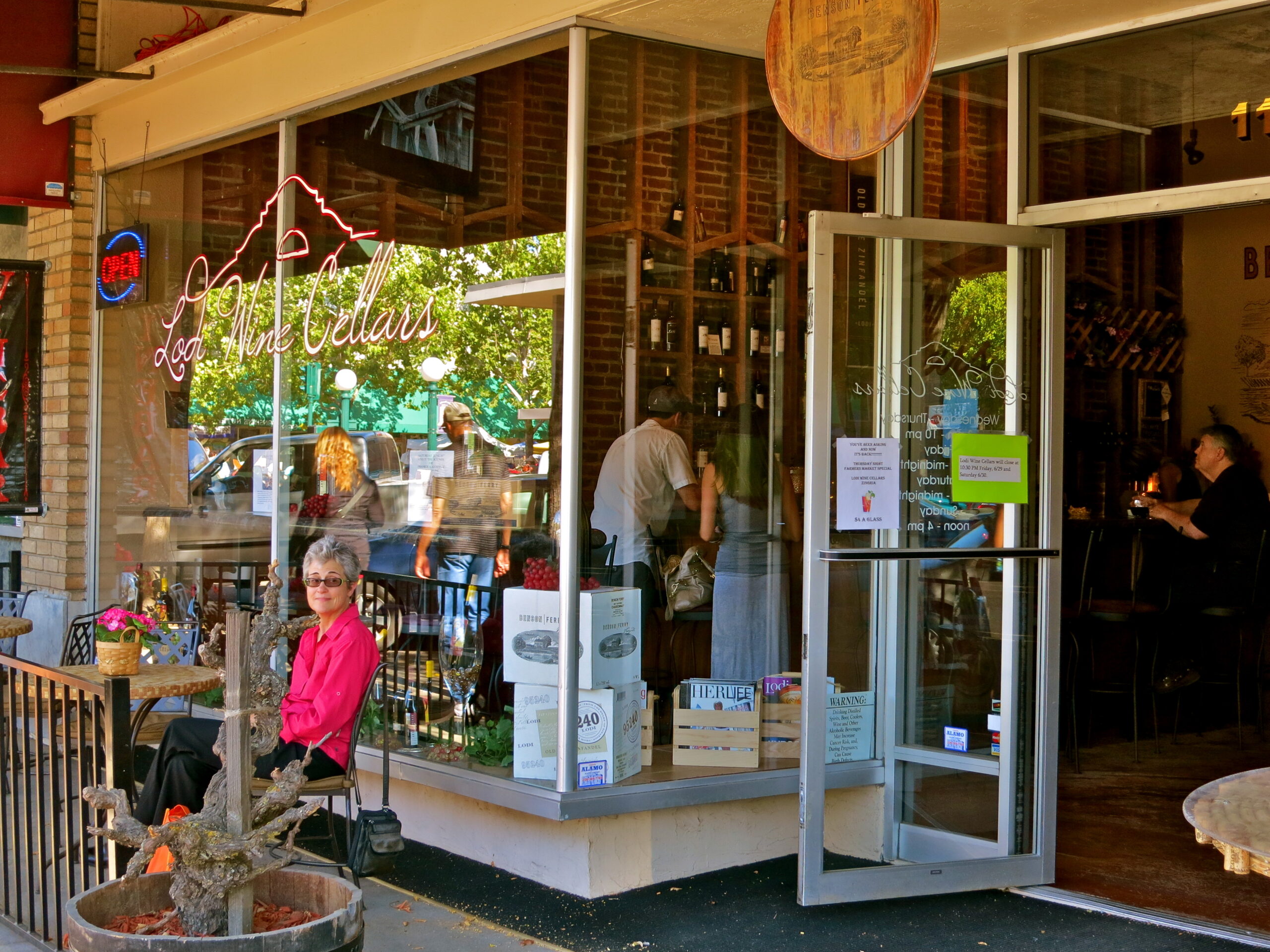 Lodi Winegrape Commission tasting room with customers and staff inside, showcasing local wines and wine-related activities.