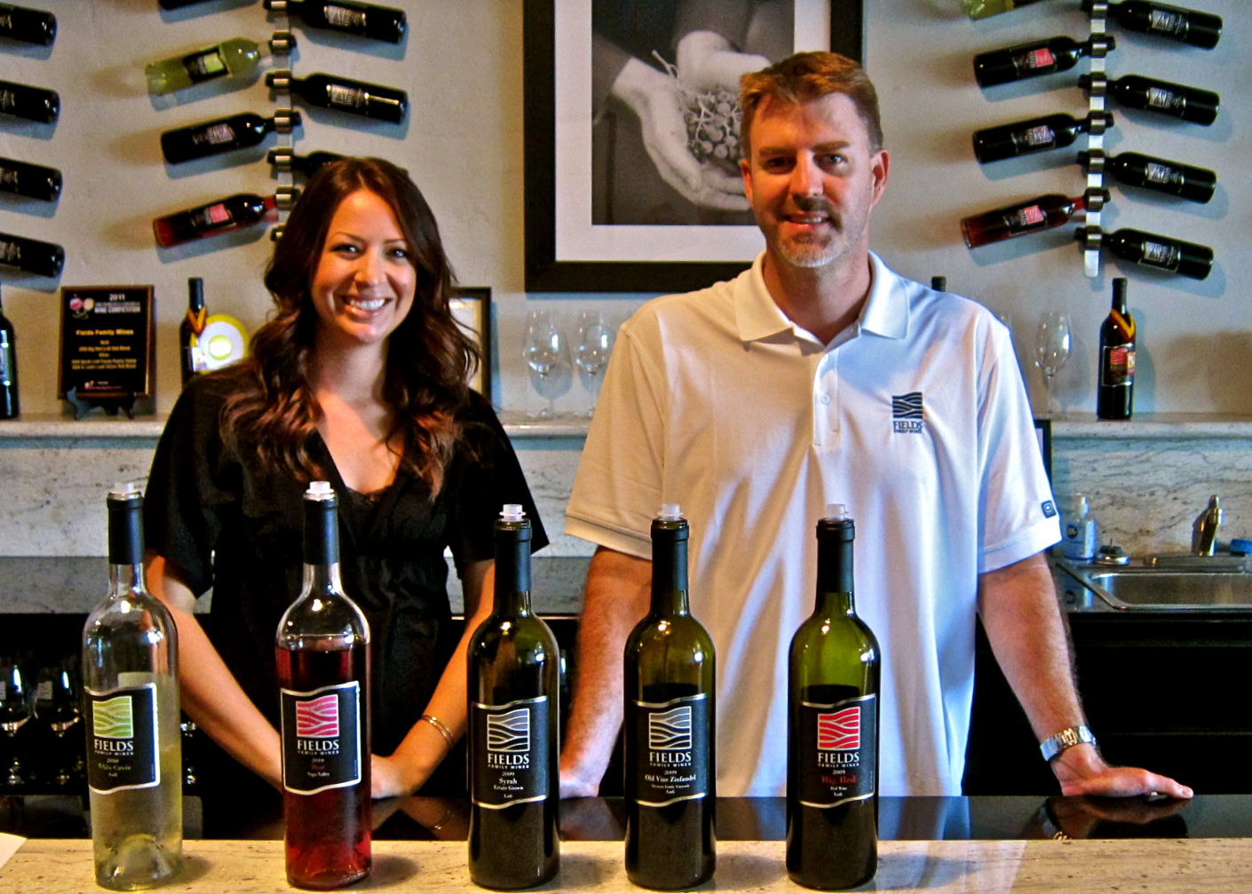 Two wine experts showcasing a selection of Lodi wines at a tasting event.