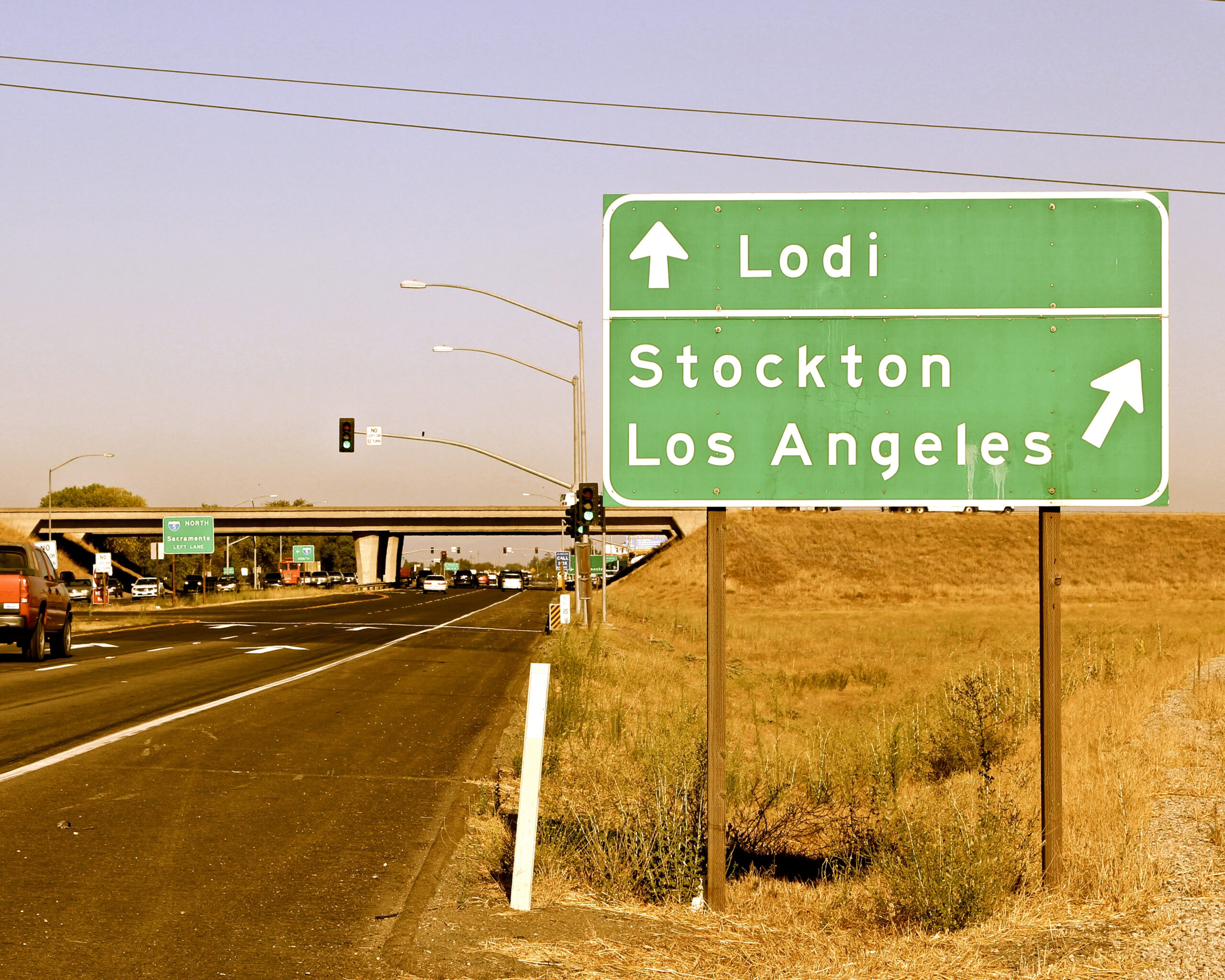 Road sign indicating directions to Lodi, Stockton, and Los Angeles in California.