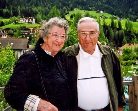 Elderly couple enjoying scenic view of vineyards and hills in Lodi, California.