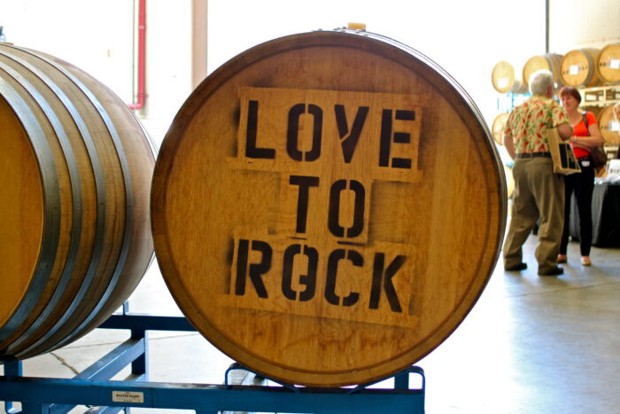 Wooden barrel with 'Love to Rock' inscription at Lodi wine event, showcasing wine culture and local winegrape industry.
