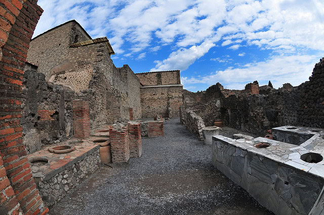 Historical ruins in Lodi wine region with stone and brick structures under a blue sky.