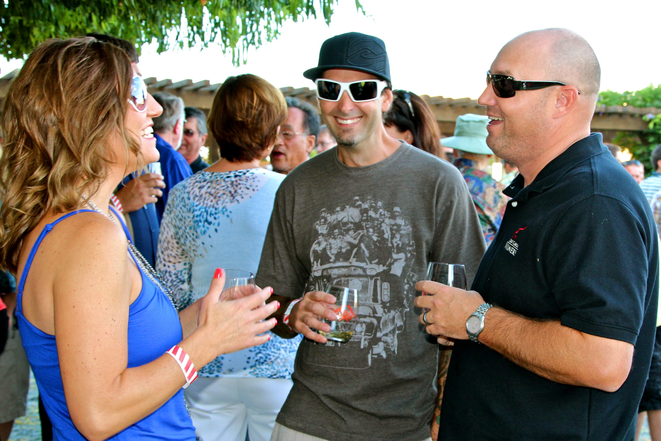 People enjoying wine tasting at a Lodi Winegrape Commission event outdoors.