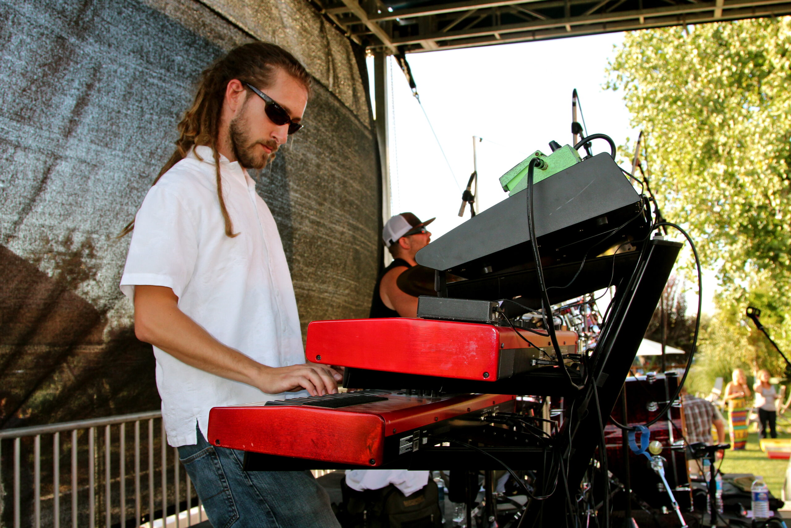 DJ performing at Lodi Winegrape Commission event with outdoor stage and audience.