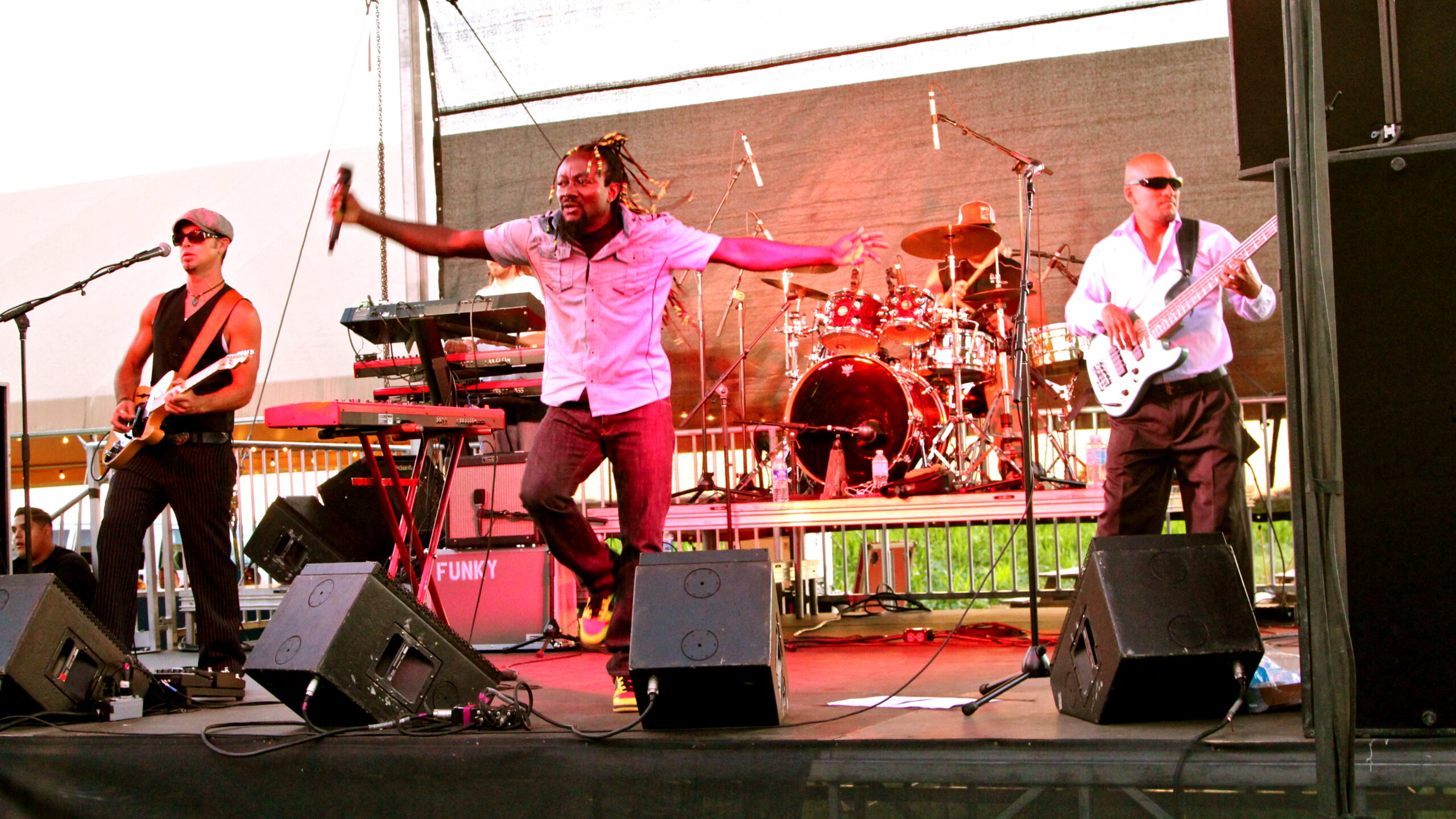 Band performing live on stage at Lodi Wine event with instruments and microphones.