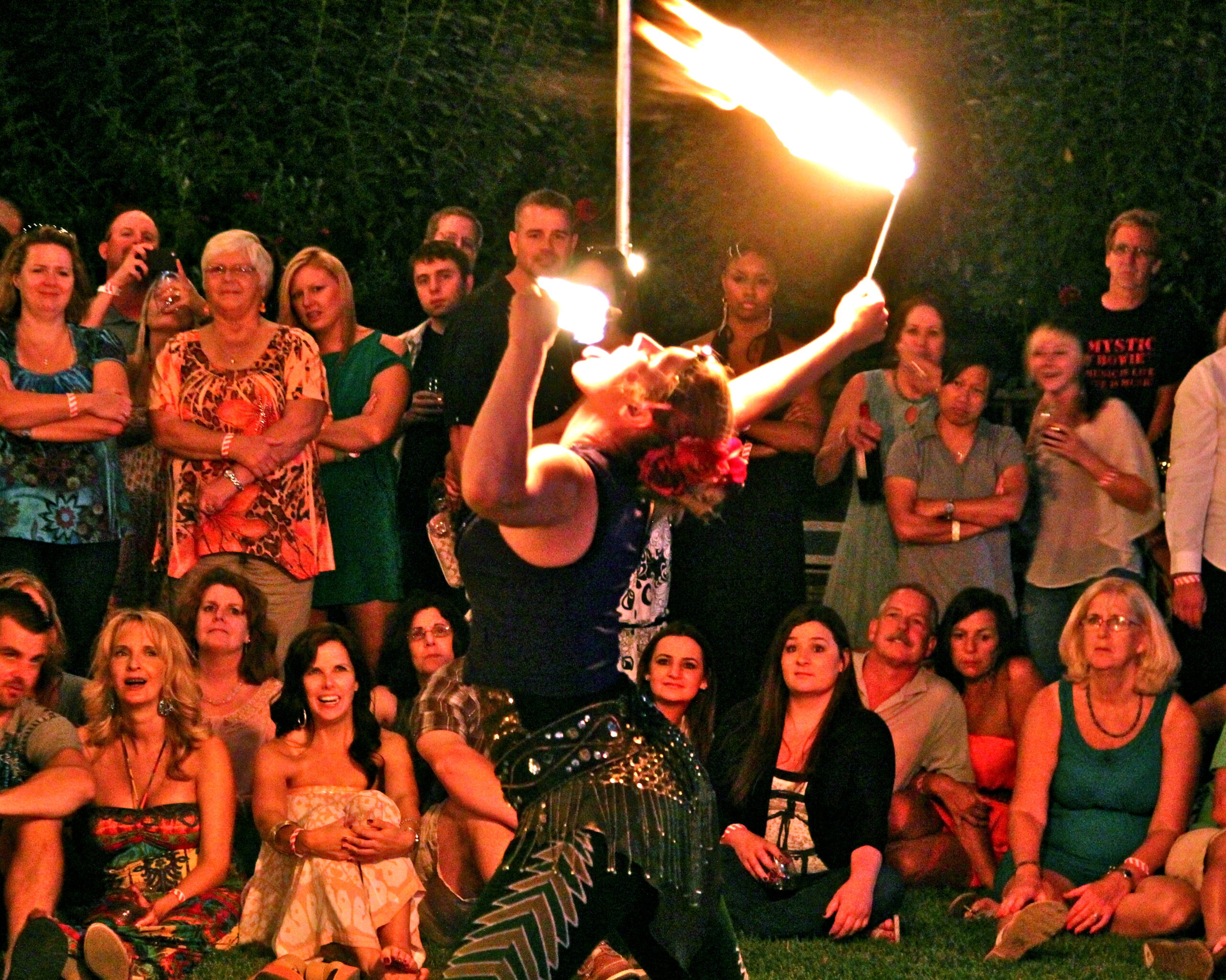 A fire performer entertains a crowd at a Lodi Winegrape Commission event in the evening.