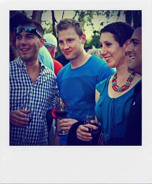 Group of people enjoying wine tasting outdoors at a Lodi Winegrape Commission event.