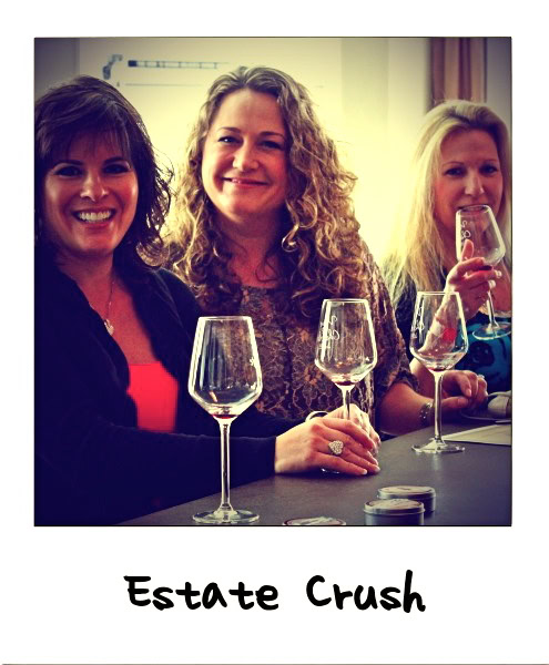 Women enjoying wine tasting at Lodi Winegrape Commission event with glasses of wine.
