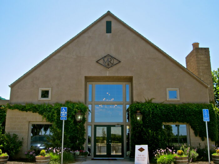 Lodi Winegrape Commission office with ivy-covered walls and a large glass entrance.
