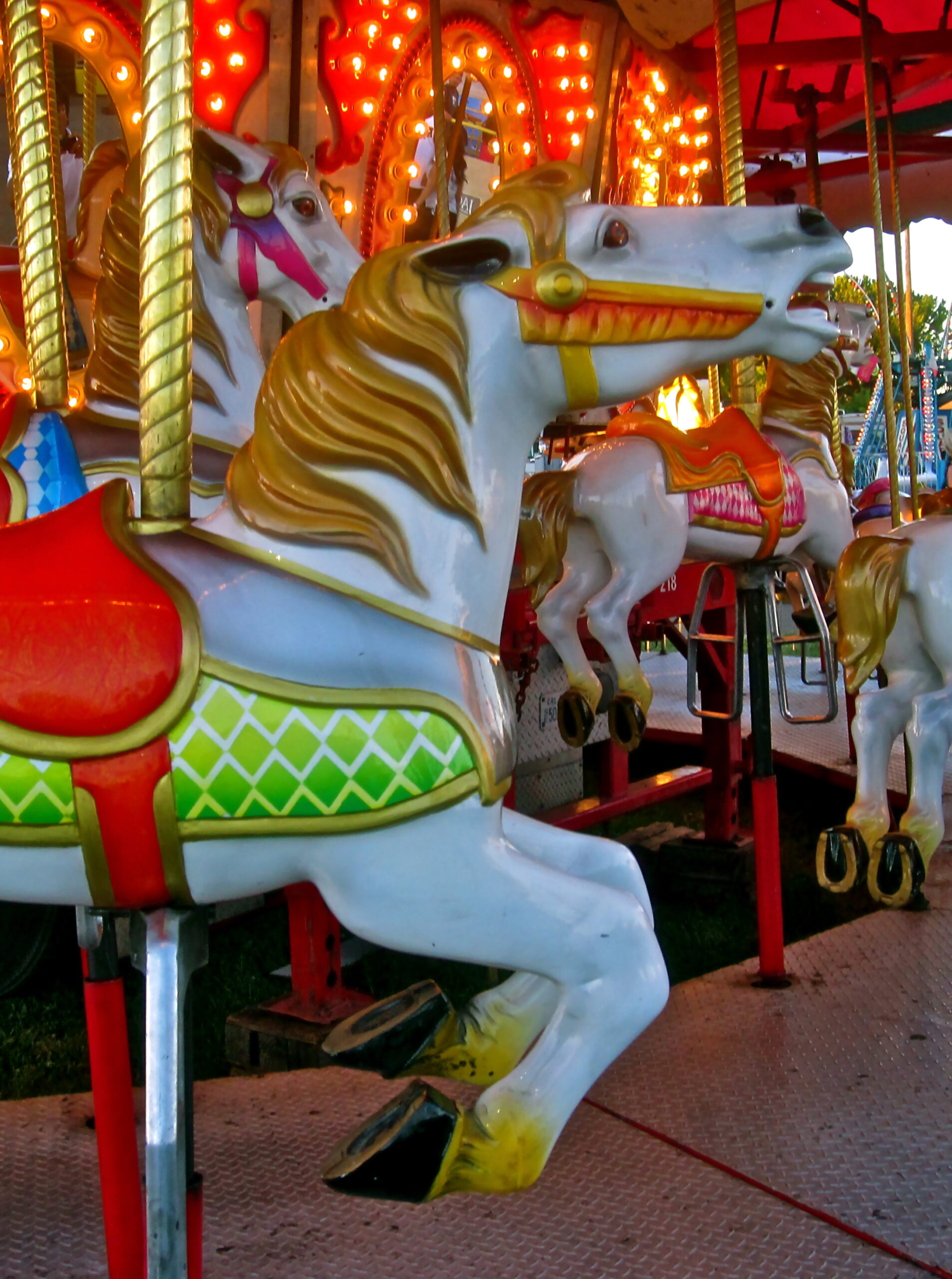 Colorful carousel horse at Lodi fair with bright lights and festive atmosphere.