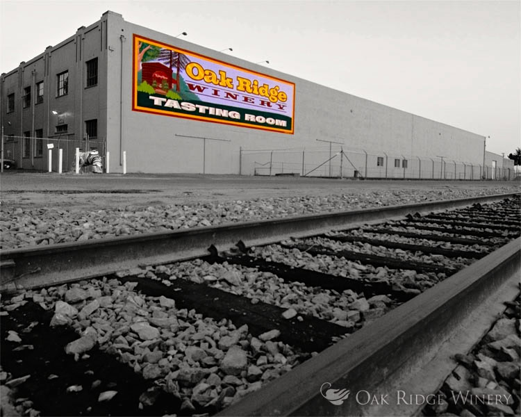 Exterior view of Oak Ridge Winery tasting room with sign and train tracks in foreground.