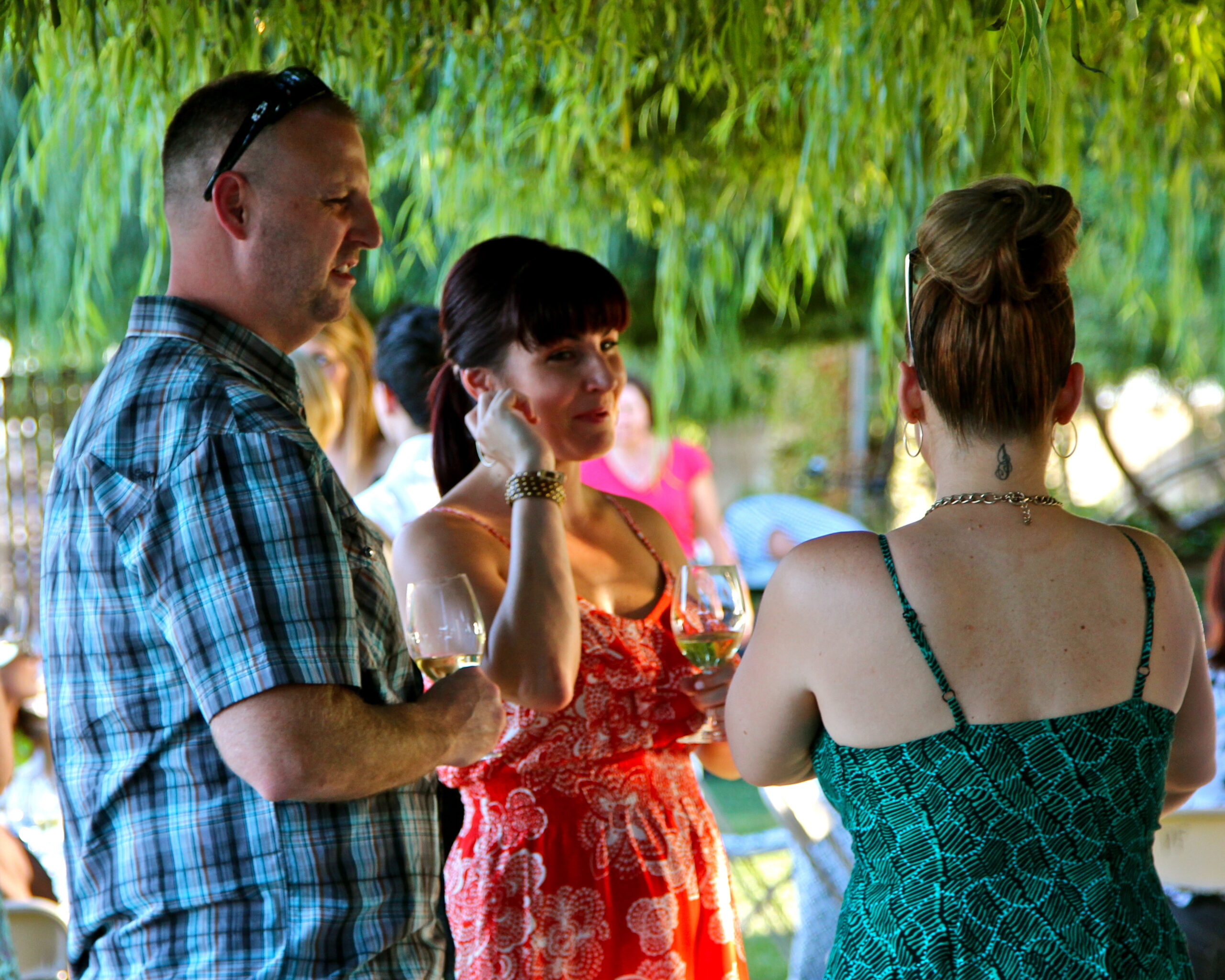 People enjoying wine tasting outdoors at a Lodi Winegrape Commission event.