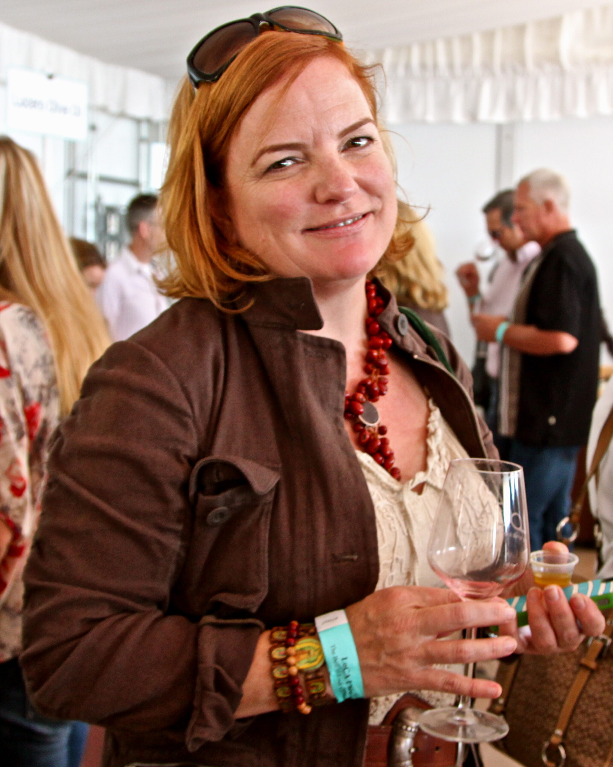 Woman at Lodi Winegrape Commission event holding a wine glass and smiling.