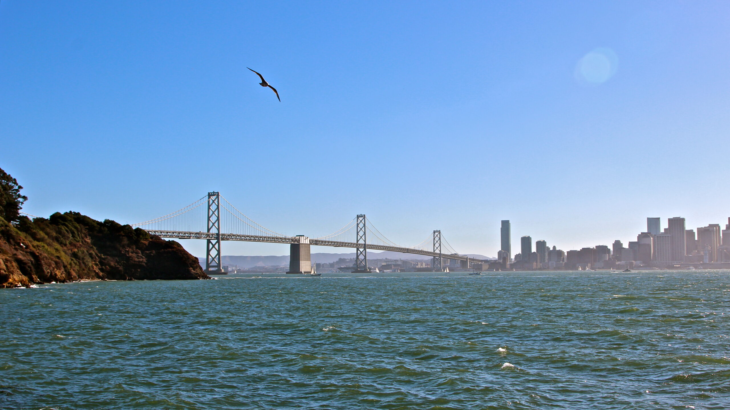 Scenic view of Lodi waterfront with bridge and city skyline under clear blue sky.