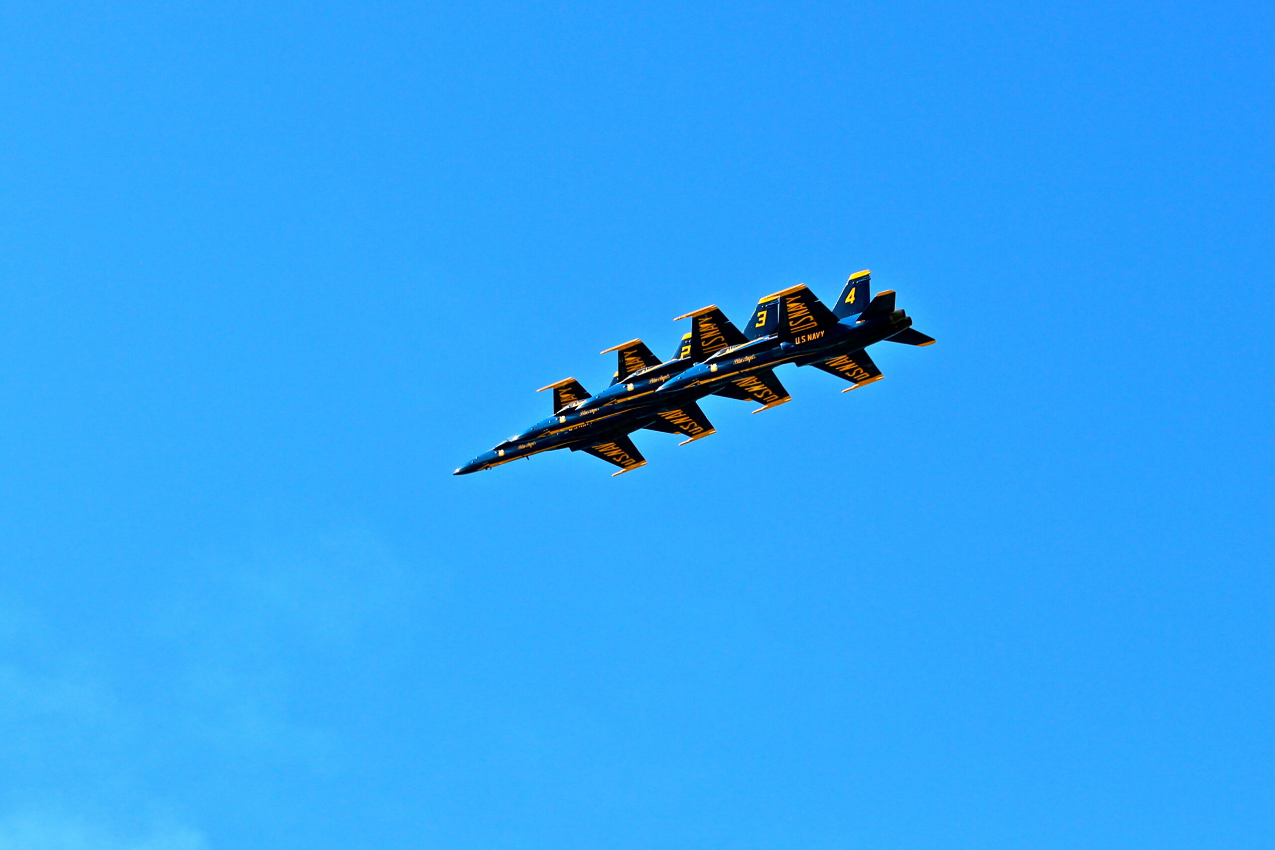 Aircraft with Lodi Winegrape Commission branding flying in clear blue sky.