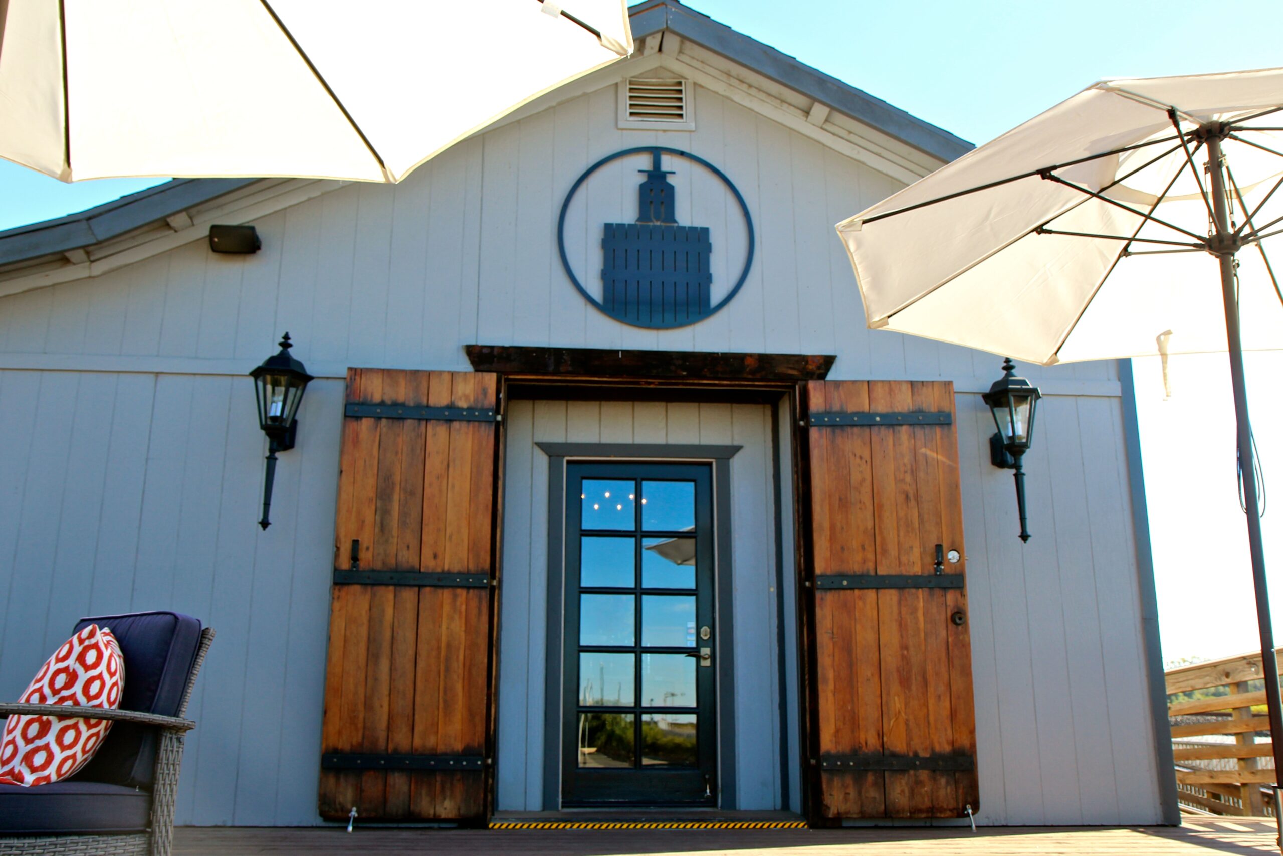 Lodi Winegrape Commission building with wooden doors and outdoor seating area.