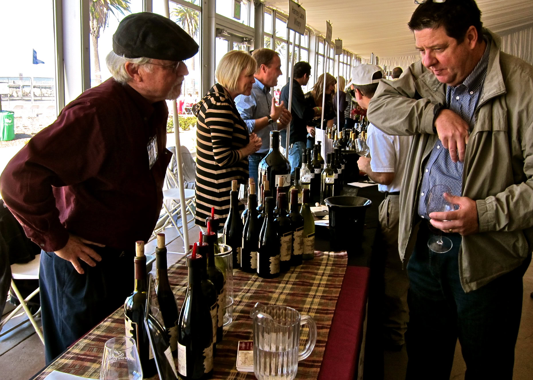 Wine tasting event at Lodi Winegrape Commission with attendees sampling wines.