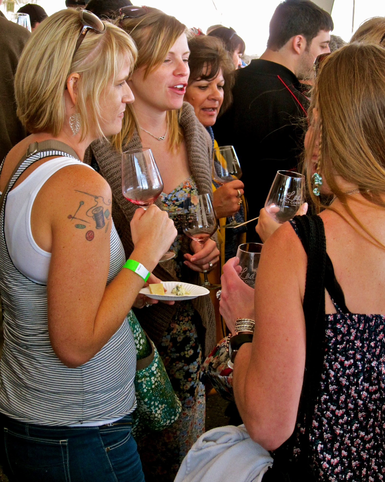 Group of people enjoying wine tasting at Lodi Winegrape Commission event.