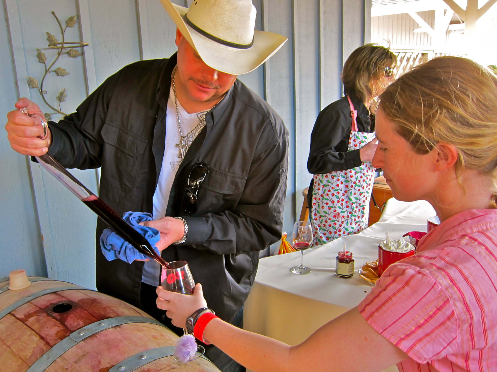 Person pouring wine into a glass at a wine tasting event in Lodi, California.