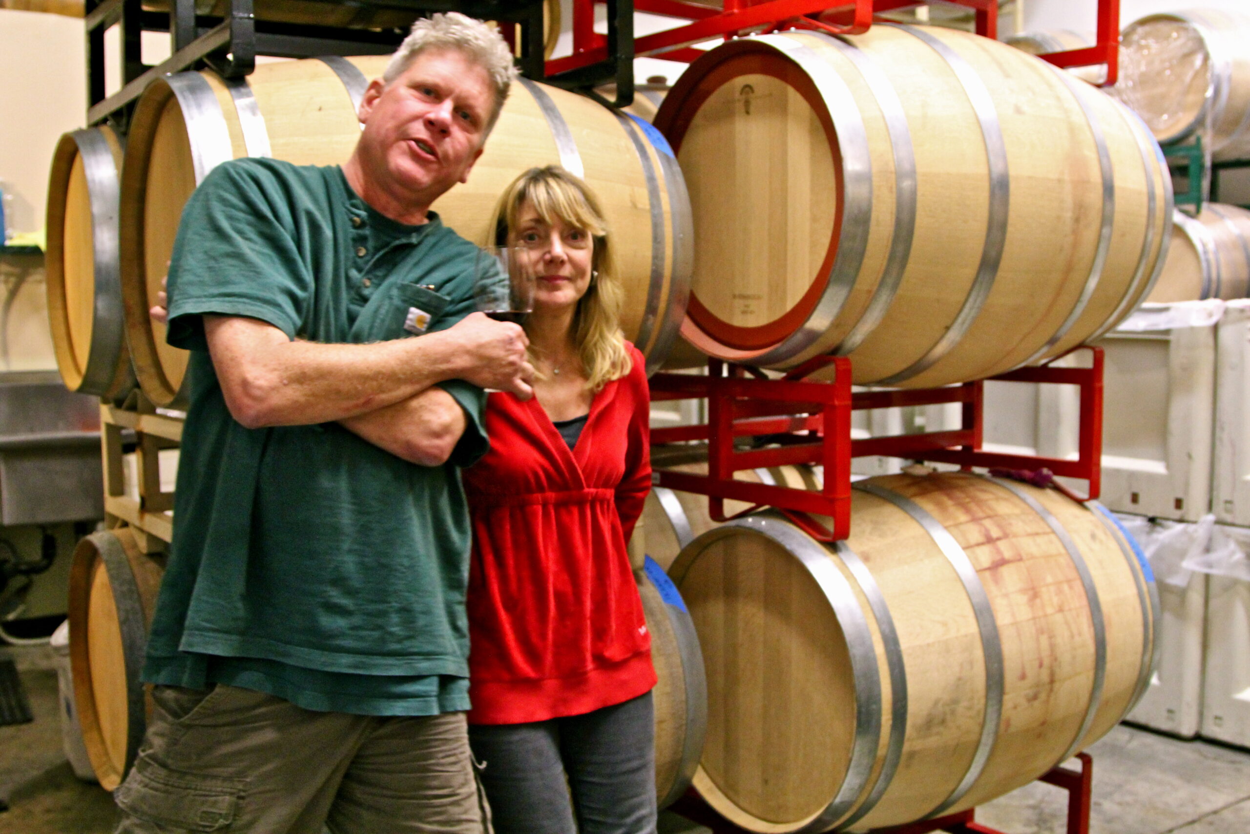 Winery staff in front of wine barrels at Lodi Winegrape Commission facility.