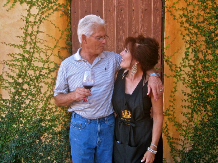 Older man and woman enjoying wine together outdoors at Lodi Winegrape Commission event.