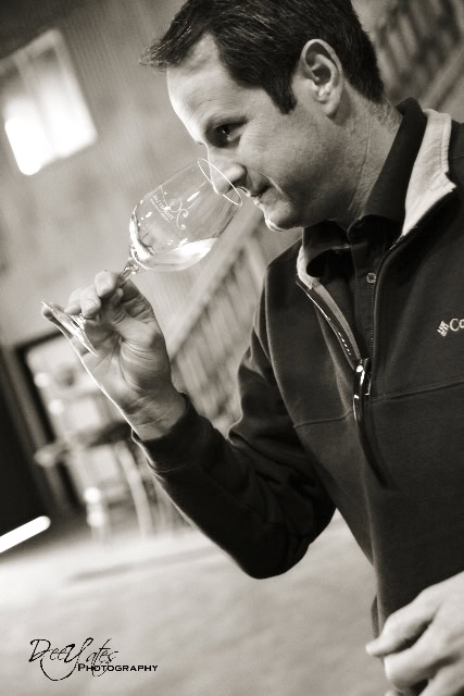 Man smelling wine in a glass at a Lodi wine tasting event, showcasing wine quality and aroma.