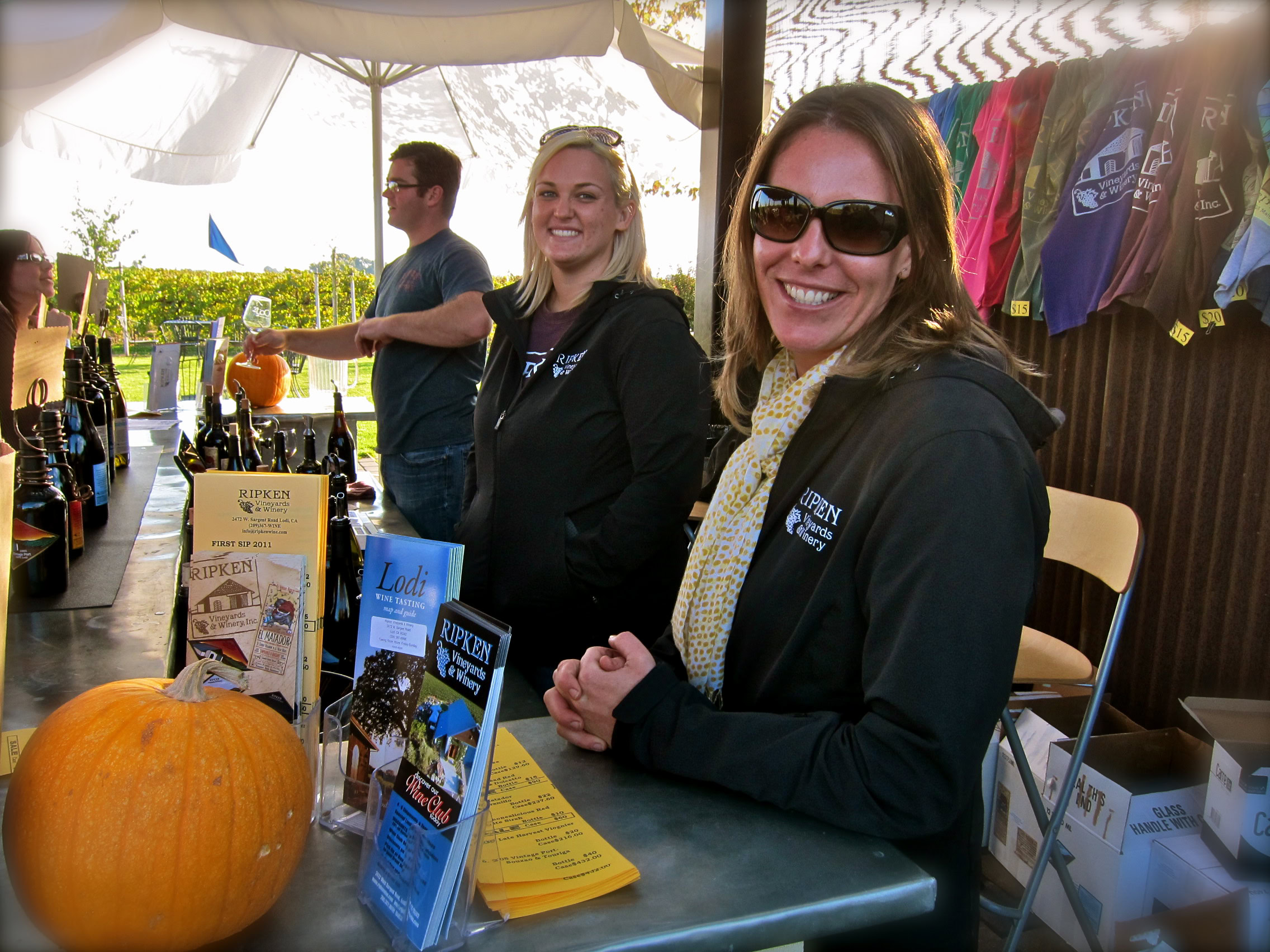 Smiling woman at Lodi Winegrape Commission booth during wine event in Lodi, California.