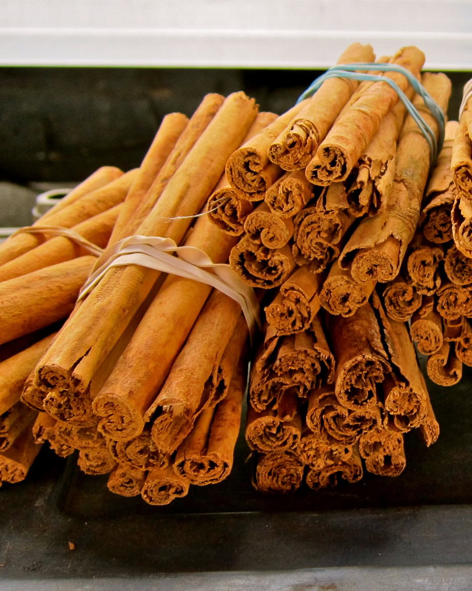 Bundles of cinnamon sticks tied with rubber bands, used in wine and culinary applications in Lodi, California.