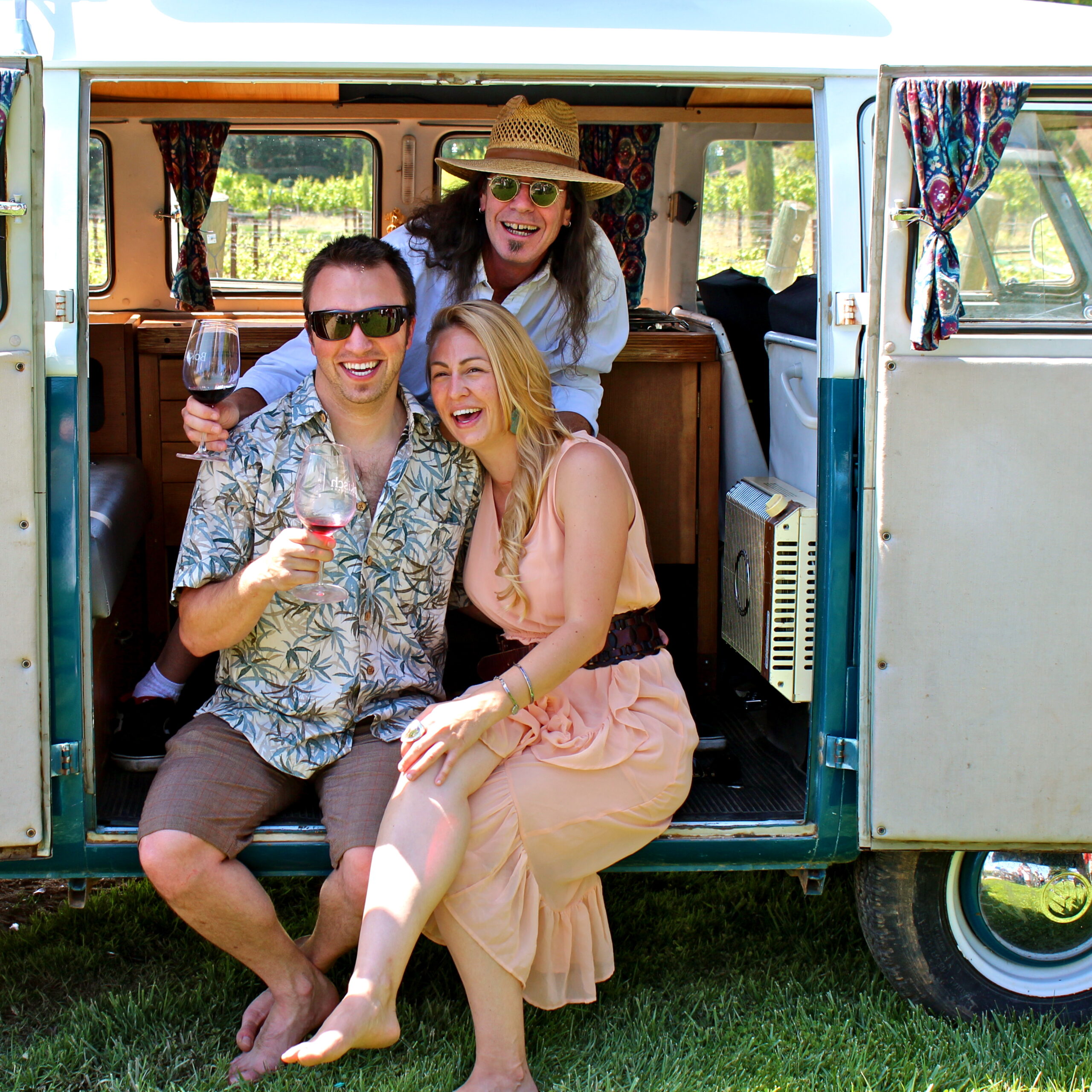 Happy friends enjoying wine and laughter at Lodi Winegrape Festival in a vintage van.