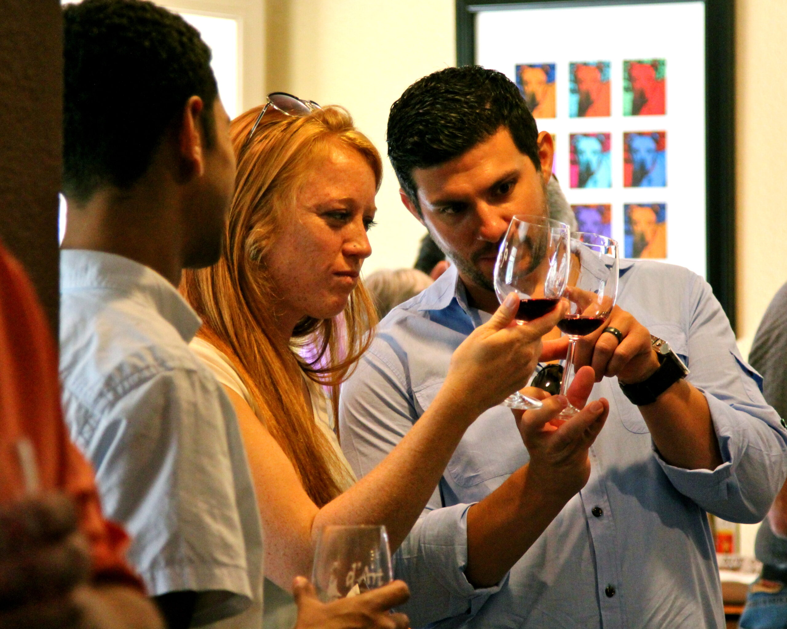Group of people enjoying wine tasting at Lodi Winegrape Commission event.