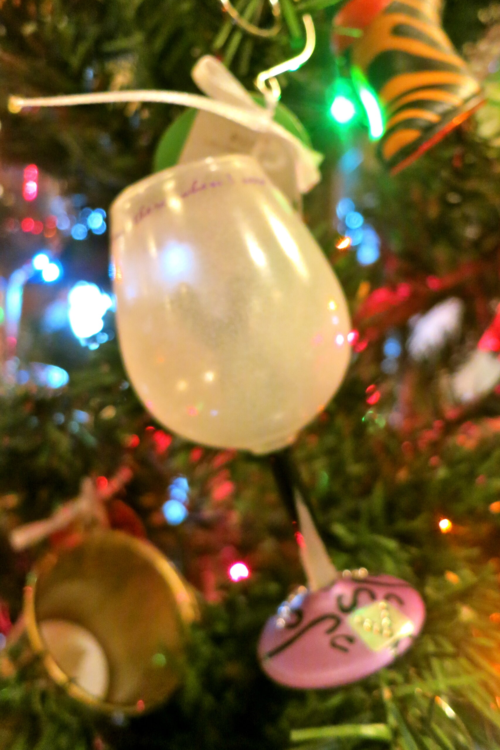 Colorful Christmas tree ornaments with lights and decorations for holiday celebration.