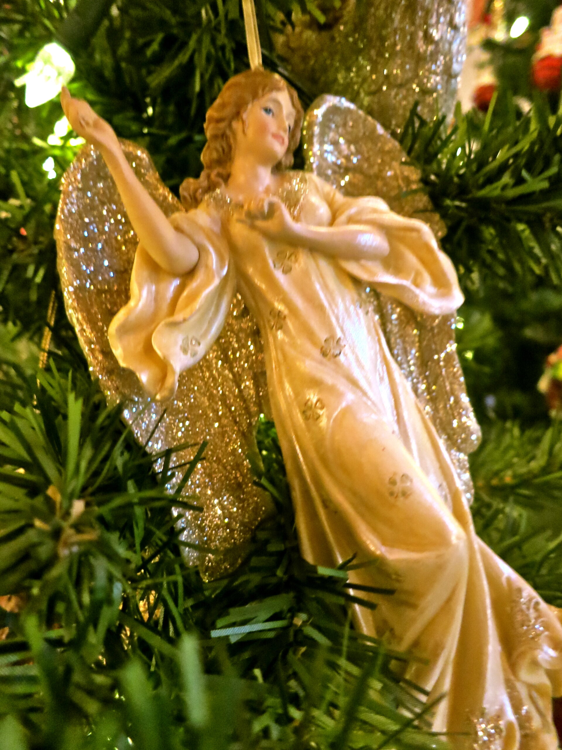 Decorative angel ornament on Christmas tree, representing Lodi Winegrape Commission's festive spirit and wine heritage.