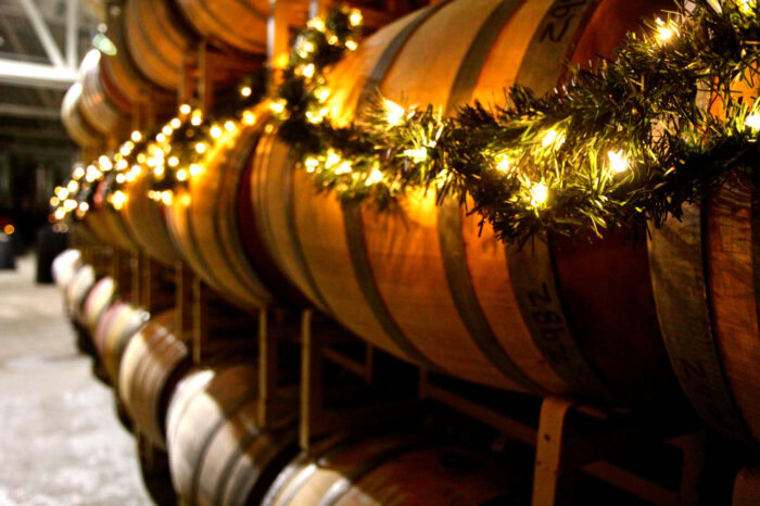 Wine barrels decorated with string lights at Lodi Winegrape Commission facility.
