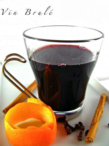 Glass of red wine with orange peel and spices, representing Lodi wine and winegrape production.