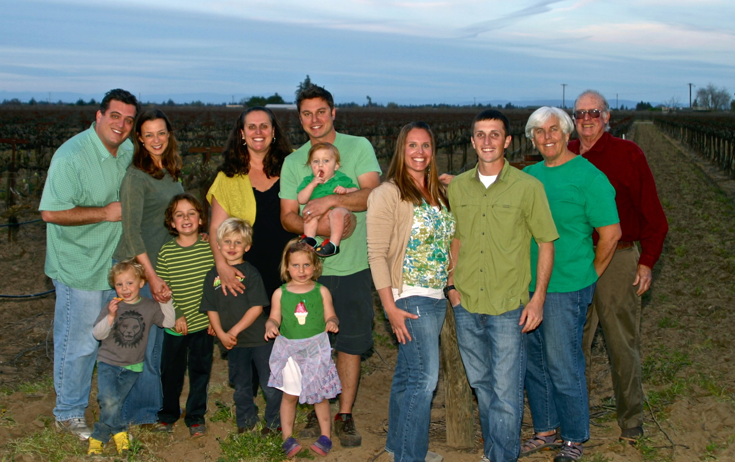 Family enjoying a day at a Lodi vineyard with grapevines in the background.