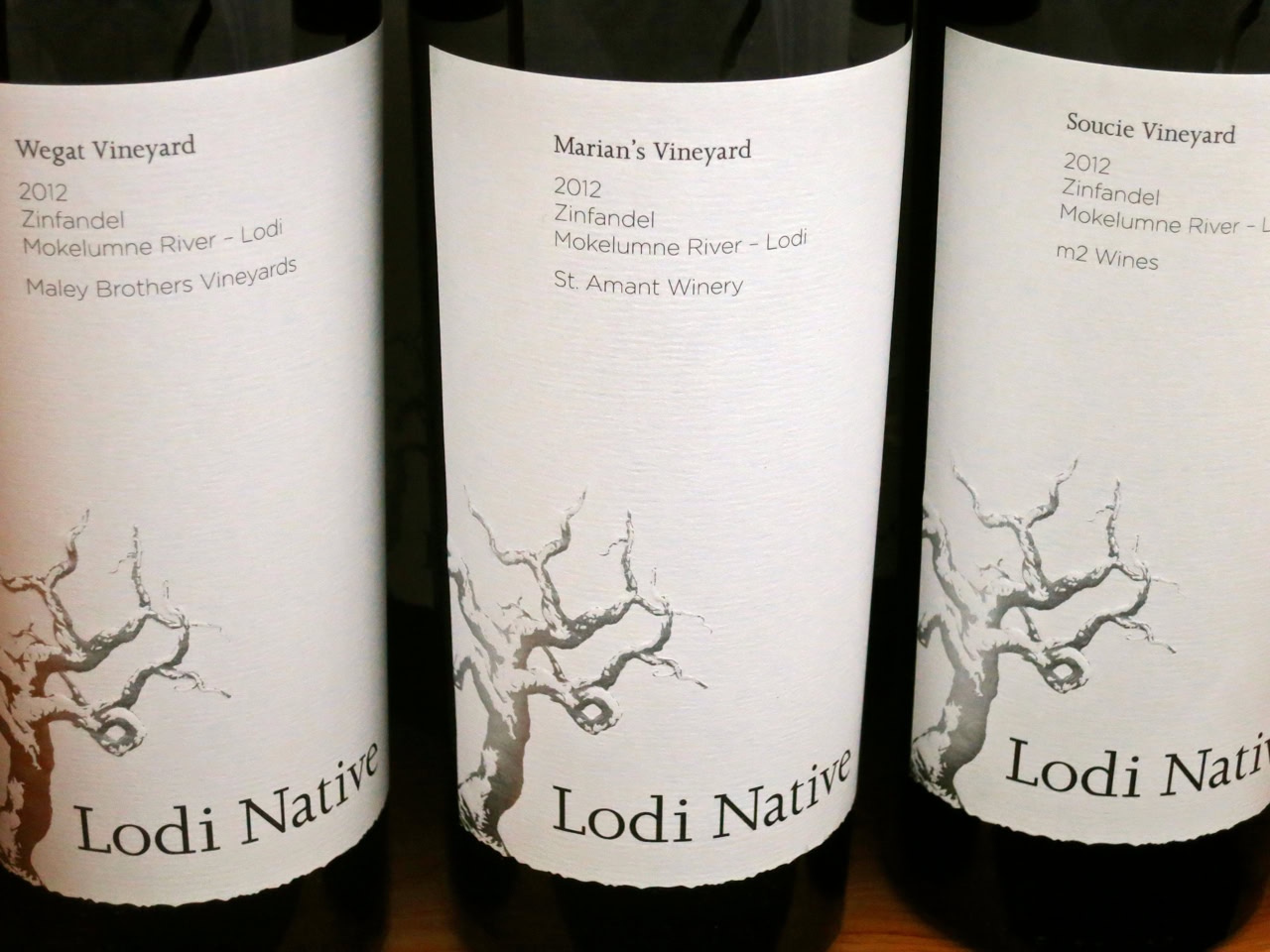Three wine bottles from Lodi Native series showcasing Zinfandel wines from 2012 vintage.