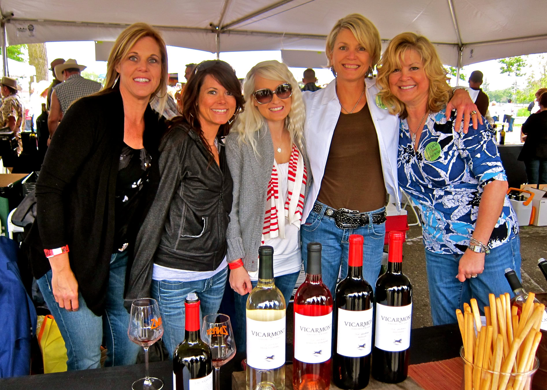 Group of women at Lodi Winegrape Commission tasting event with wine bottles and glasses.