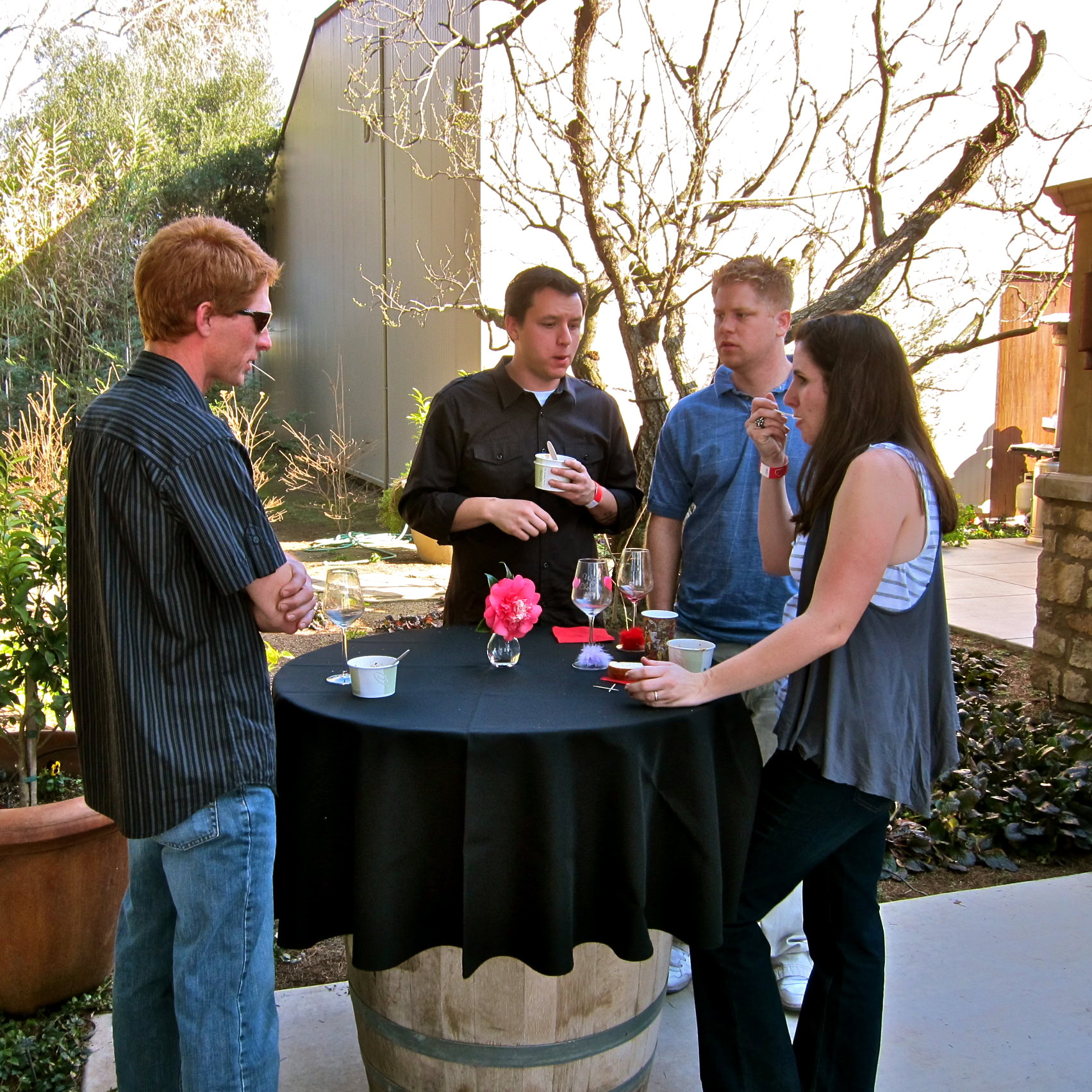 Group of people enjoying wine tasting outdoors at a Lodi Winegrape Commission event.