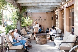 Outdoor patio at Lodi Winegrape Commission with seating and greenery for wine tasting and events.