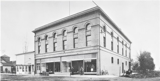 Historic black and white photo of the Lodi Winegrape Commission building with people outside.