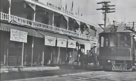Black and white photo of a vintage street scene in Lodi with a trolley and storefronts.