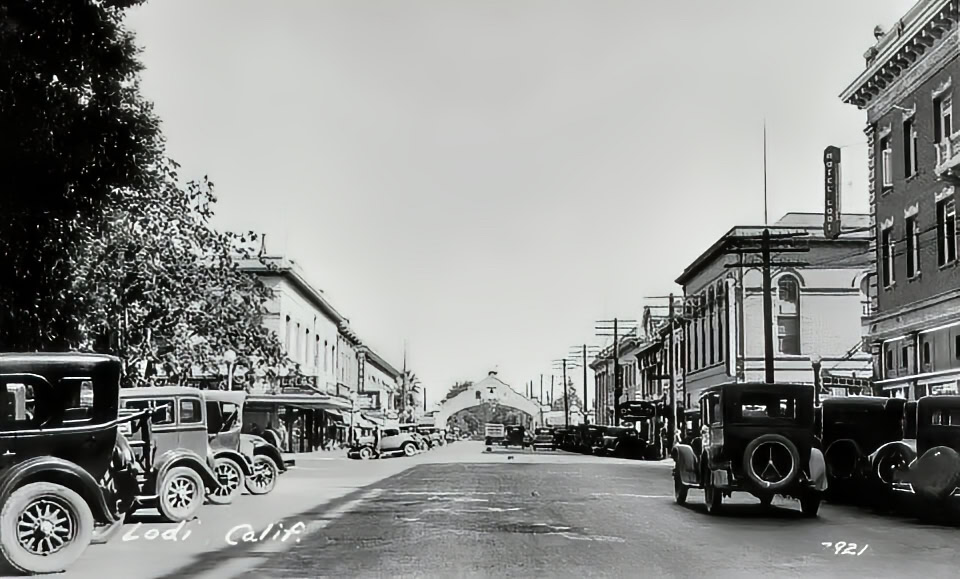 Black and white photo of historic downtown Lodi with vintage cars and old buildings from the 1920s.
