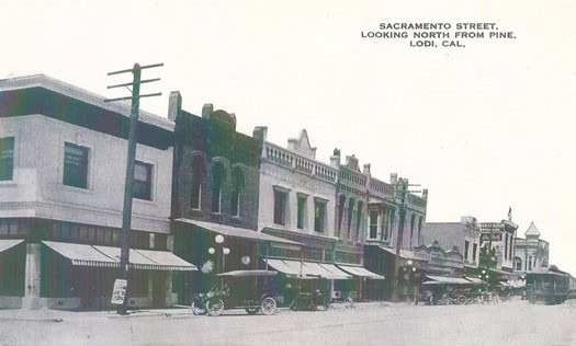 Vintage photo of Sacramento Street in Lodi, California, showing old buildings and storefronts from the early 20th century.